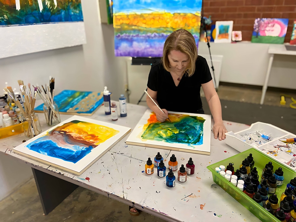 Anya McManis painting in her art studio